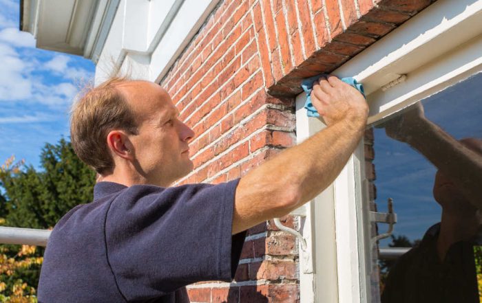 Man cleaning Vinyl Window Frames